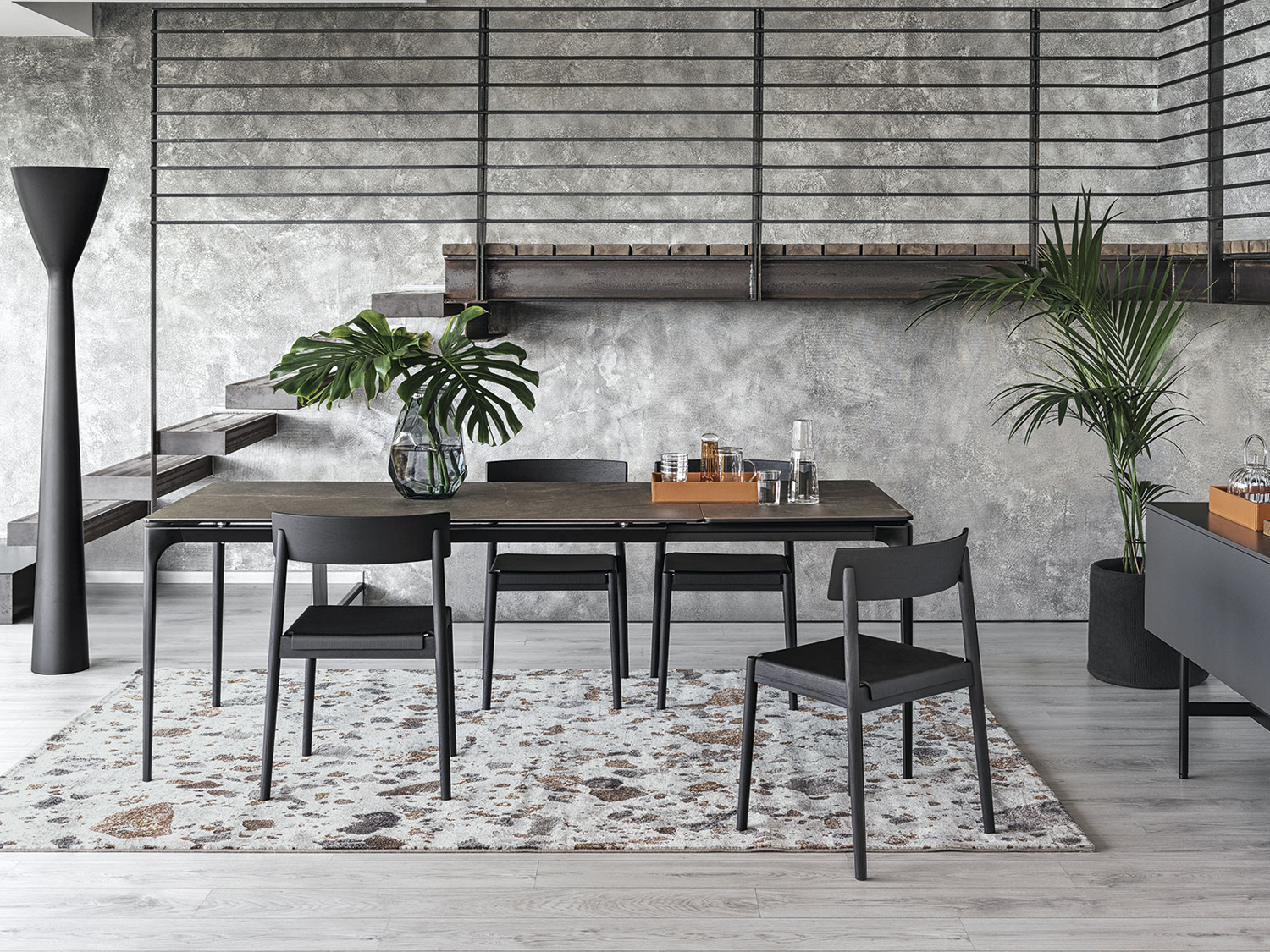 Housing Units dining room display with contemporary furniture and plants